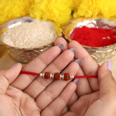 Three Rudraksha With Silver Beads Rakhi